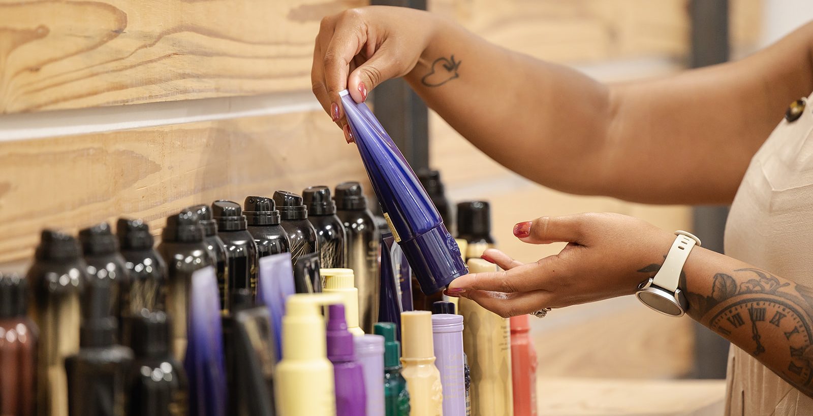 Stylist selecting product from the Uberzoot shelf